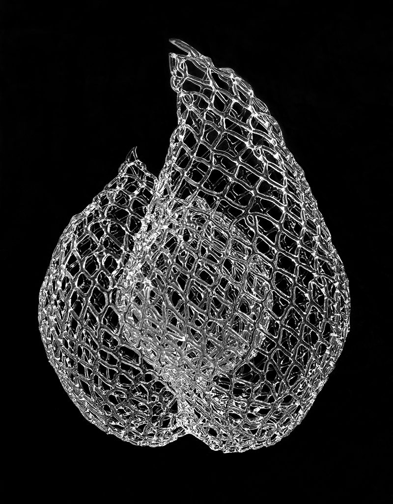 Glass net like sculpture on black background